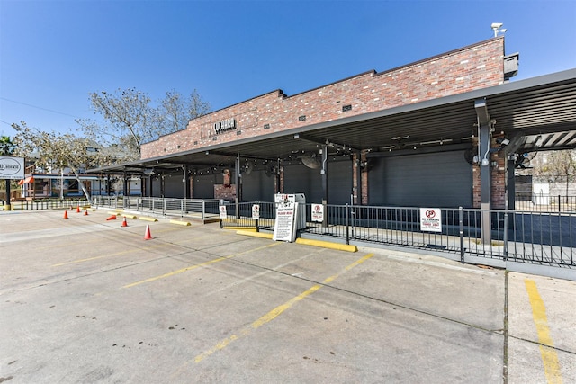 view of building exterior featuring uncovered parking