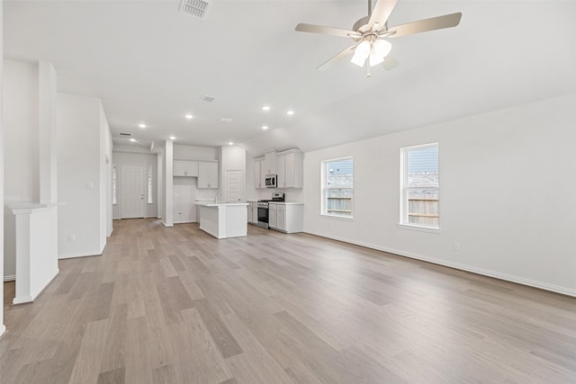 5830 Westwood Shore Dr, Katy, TX 77493 - unfurnished living room featuring light wood-style floors, a sink, baseboards, a ceiling fan, and recessed lighting