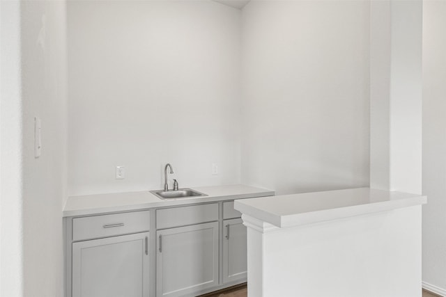 5830 Westwood Shore Dr, Katy, TX 77493 - bar featuring a sink and light wood-style flooring
