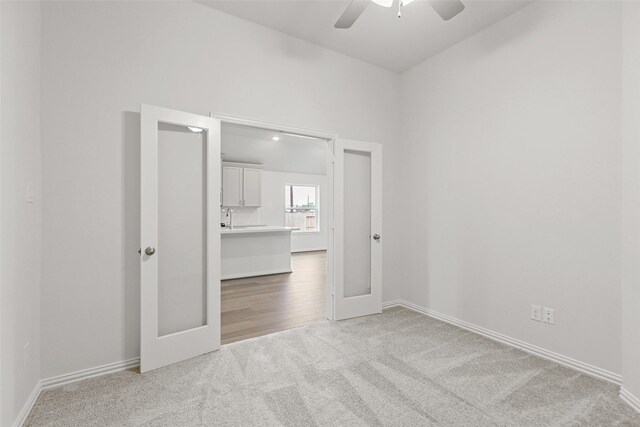 5830 Westwood Shore Dr, Katy, TX 77493 - spare room featuring carpet floors, french doors, a ceiling fan, and baseboards