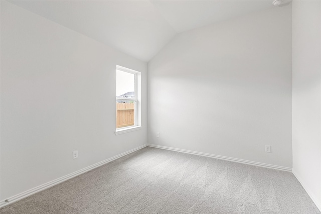 5830 Westwood Shore Dr, Katy, TX 77493 - spare room featuring carpet, lofted ceiling, and baseboards