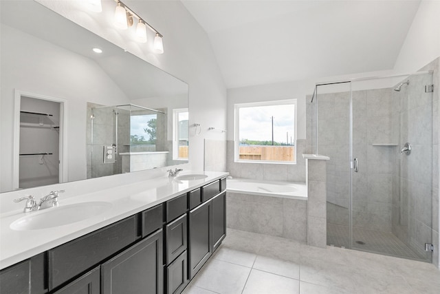 5830 Westwood Shore Dr, Katy, TX 77493 - bathroom with vaulted ceiling, a stall shower, tile patterned floors, a garden tub, and double vanity