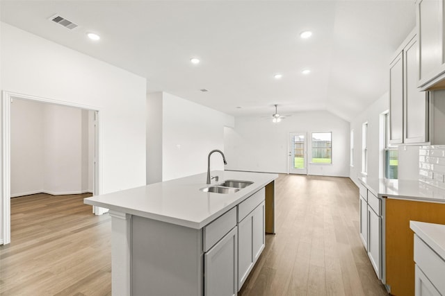 5830 Westwood Shore Dr, Katy, TX 77493 - kitchen featuring ceiling fan, light countertops, light wood-type flooring, open floor plan, and vaulted ceiling