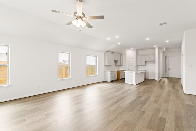 5830 Westwood Shore Dr, Katy, TX 77493 - unfurnished living room featuring light wood-type flooring, ceiling fan, recessed lighting, and lofted ceiling