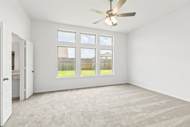 5830 Westwood Shore Dr, Katy, TX 77493 - unfurnished bedroom with light carpet, multiple windows, and a ceiling fan