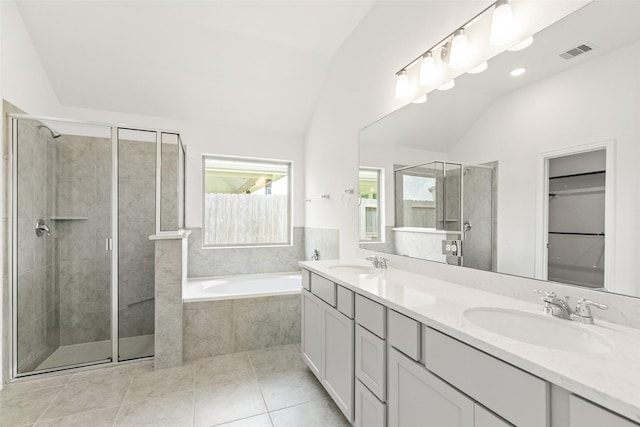 5830 Westwood Shore Dr, Katy, TX 77493 - bathroom with lofted ceiling, a stall shower, double vanity, a bath, and tile patterned floors