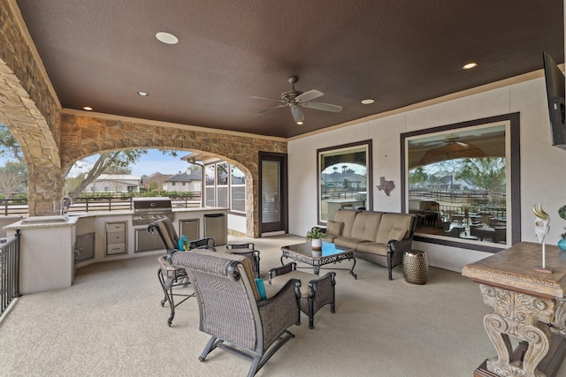 view of patio with a grill, outdoor lounge area, ceiling fan, and exterior kitchen