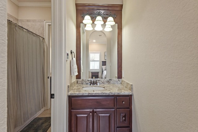 bathroom featuring ornamental molding, curtained shower, and vanity