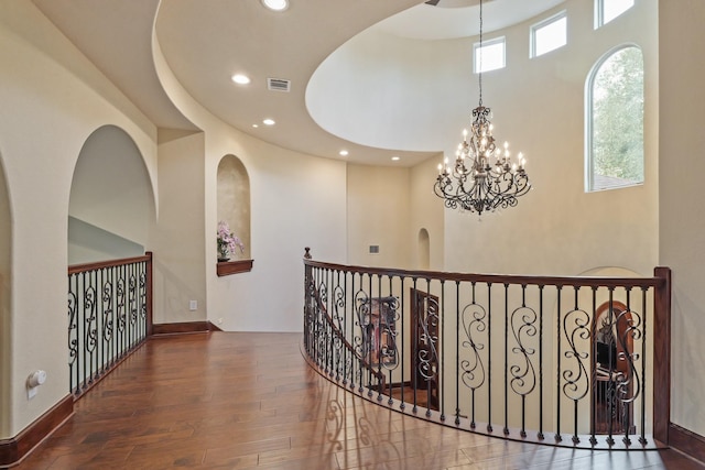 hall featuring a high ceiling and dark wood-type flooring