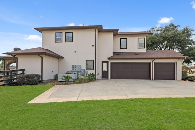 back of property with a yard and a garage