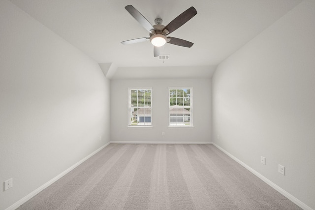 unfurnished room featuring light carpet, baseboards, a ceiling fan, and visible vents