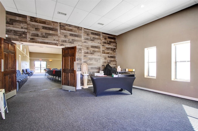 carpeted home office featuring a paneled ceiling