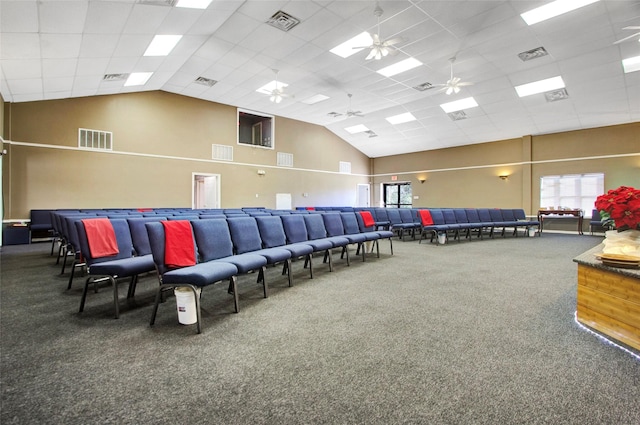 home theater room featuring ceiling fan, carpet floors, a drop ceiling, and high vaulted ceiling