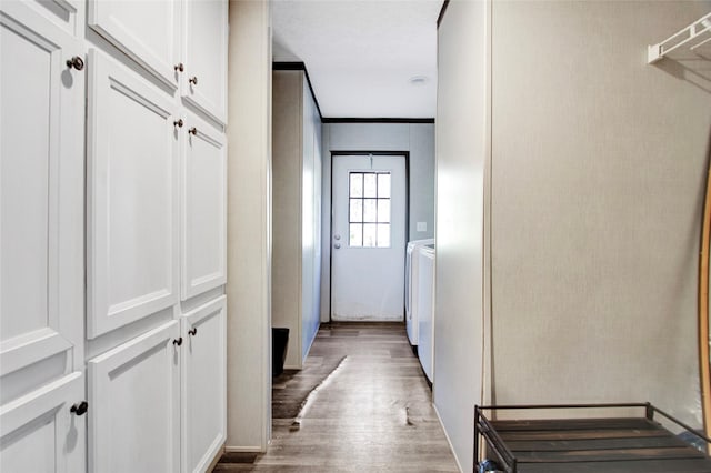 corridor featuring wood-type flooring and washing machine and dryer