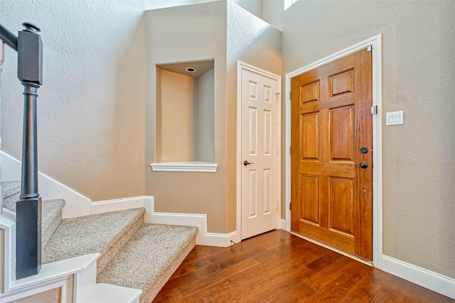 foyer entrance with dark hardwood / wood-style floors