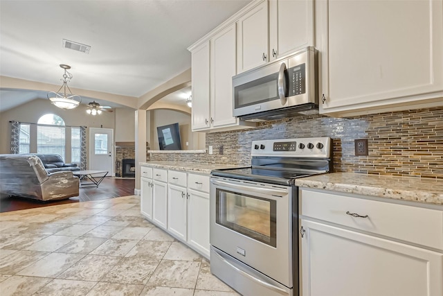 kitchen with white cabinetry, backsplash, decorative light fixtures, and appliances with stainless steel finishes