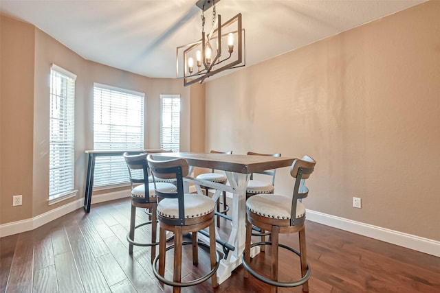 dining space featuring a chandelier and dark hardwood / wood-style flooring