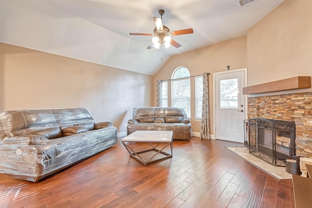 living room with vaulted ceiling, ceiling fan, a fireplace, and hardwood / wood-style floors