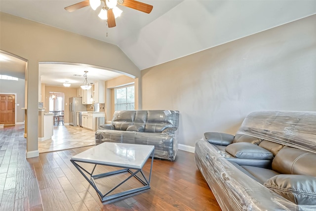 living room featuring lofted ceiling, hardwood / wood-style floors, and ceiling fan