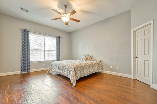 bedroom with ceiling fan, dark hardwood / wood-style floors, and vaulted ceiling