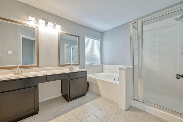 bathroom with vanity and shower with separate bathtub