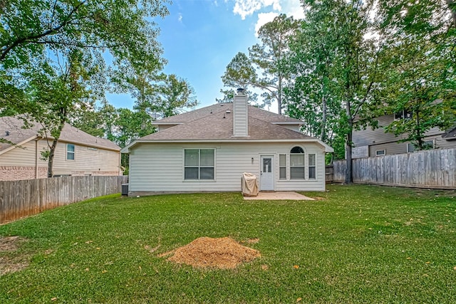 back of property with a patio, a yard, and cooling unit