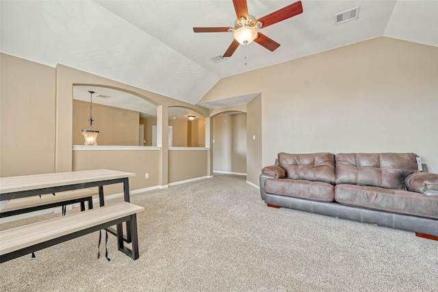 carpeted living room with lofted ceiling and ceiling fan