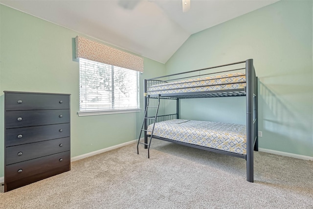 carpeted bedroom featuring vaulted ceiling and ceiling fan