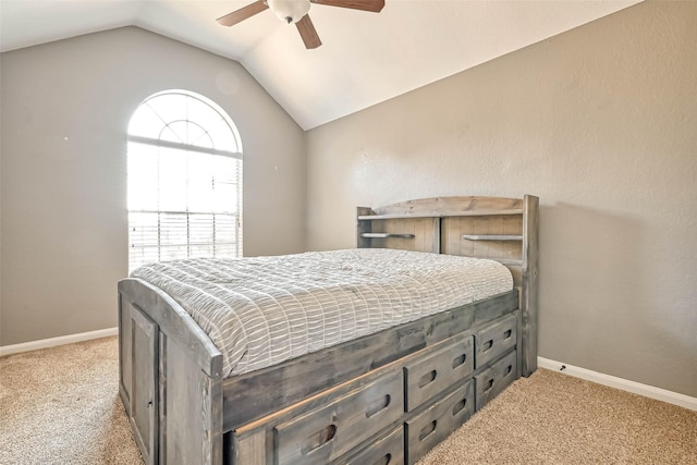 carpeted bedroom with vaulted ceiling and ceiling fan