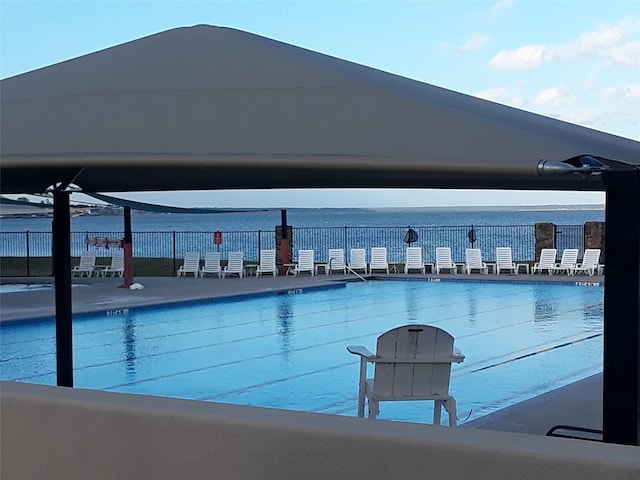 view of pool with a water view