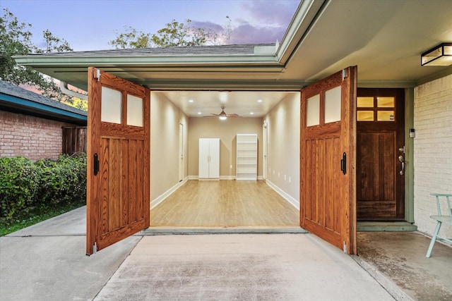 exterior entry at dusk featuring ceiling fan