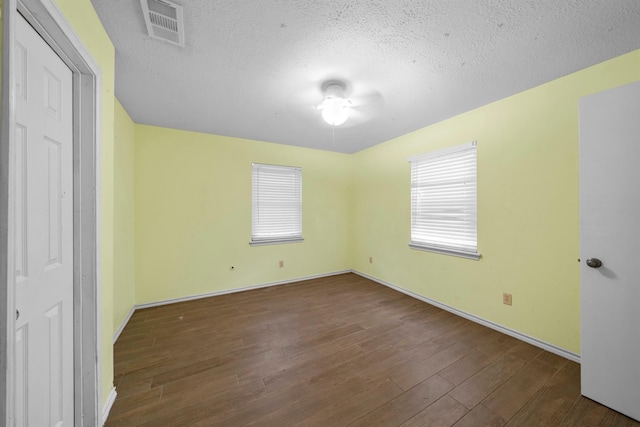 unfurnished bedroom featuring dark wood-type flooring and a textured ceiling