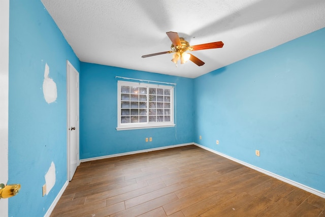 unfurnished room with hardwood / wood-style floors, a textured ceiling, and ceiling fan