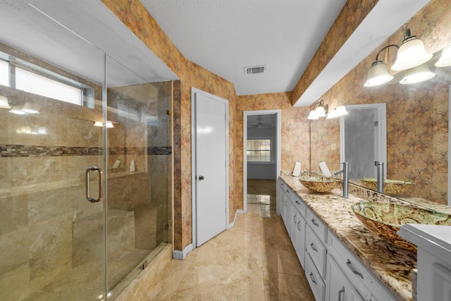 bathroom featuring vanity and an enclosed shower