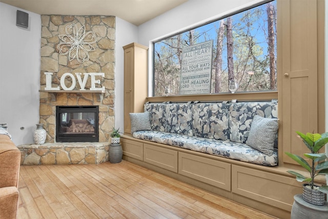 interior space with a fireplace and light wood finished floors