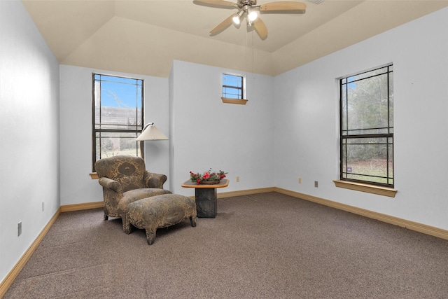 living area with a wealth of natural light, carpet, vaulted ceiling, and baseboards