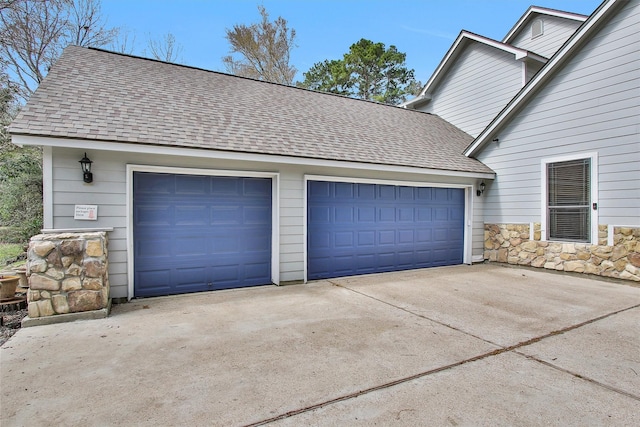 garage with concrete driveway