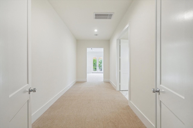 hall featuring light colored carpet, visible vents, baseboards, and recessed lighting