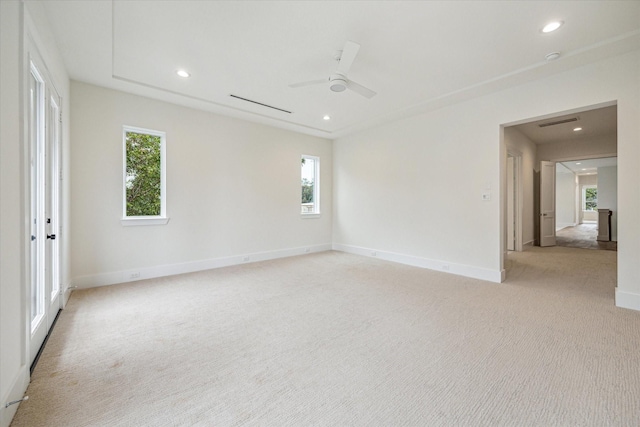 empty room featuring light carpet, baseboards, a ceiling fan, and recessed lighting