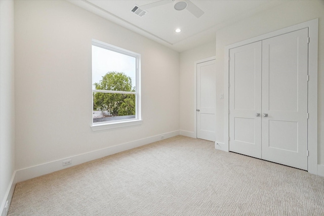 unfurnished bedroom featuring recessed lighting, a closet, visible vents, light carpet, and baseboards