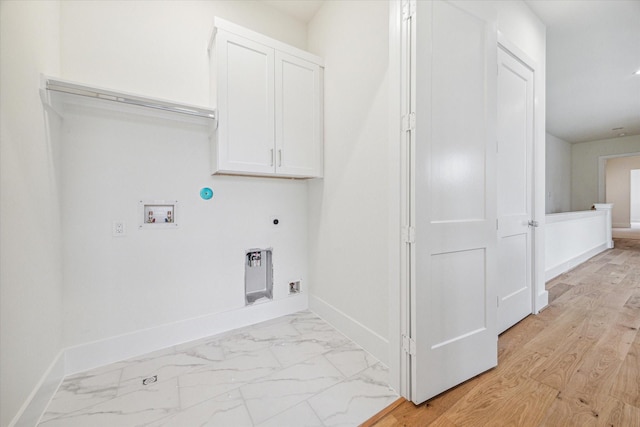 laundry room with baseboards, washer hookup, cabinet space, and electric dryer hookup