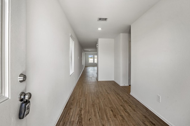 corridor with dark hardwood / wood-style floors