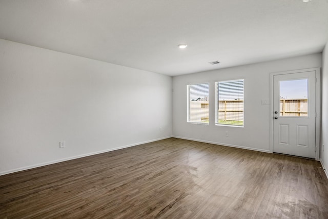 spare room with dark hardwood / wood-style flooring