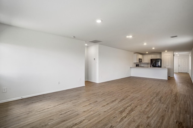 unfurnished living room featuring hardwood / wood-style floors