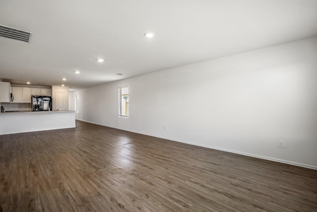 unfurnished living room with dark hardwood / wood-style flooring