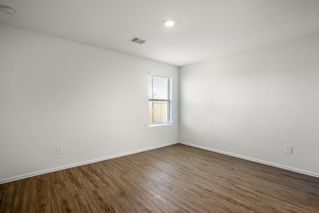 empty room featuring dark wood-type flooring