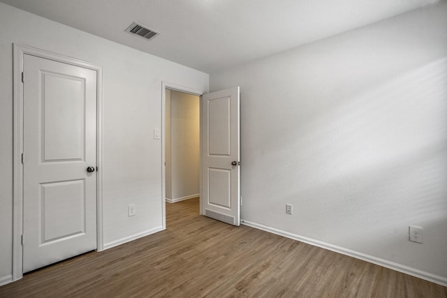 unfurnished bedroom with wood-type flooring