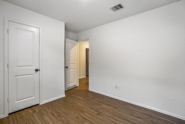 unfurnished bedroom featuring dark hardwood / wood-style floors