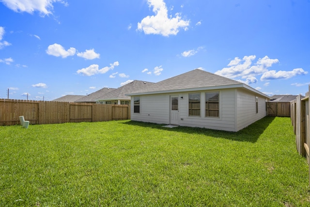 back of house with a lawn