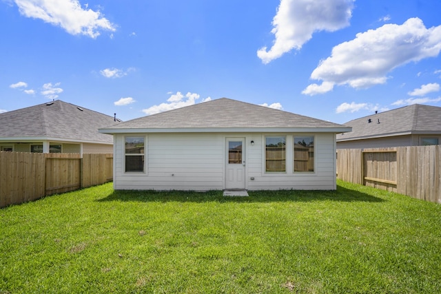 back of house featuring a lawn